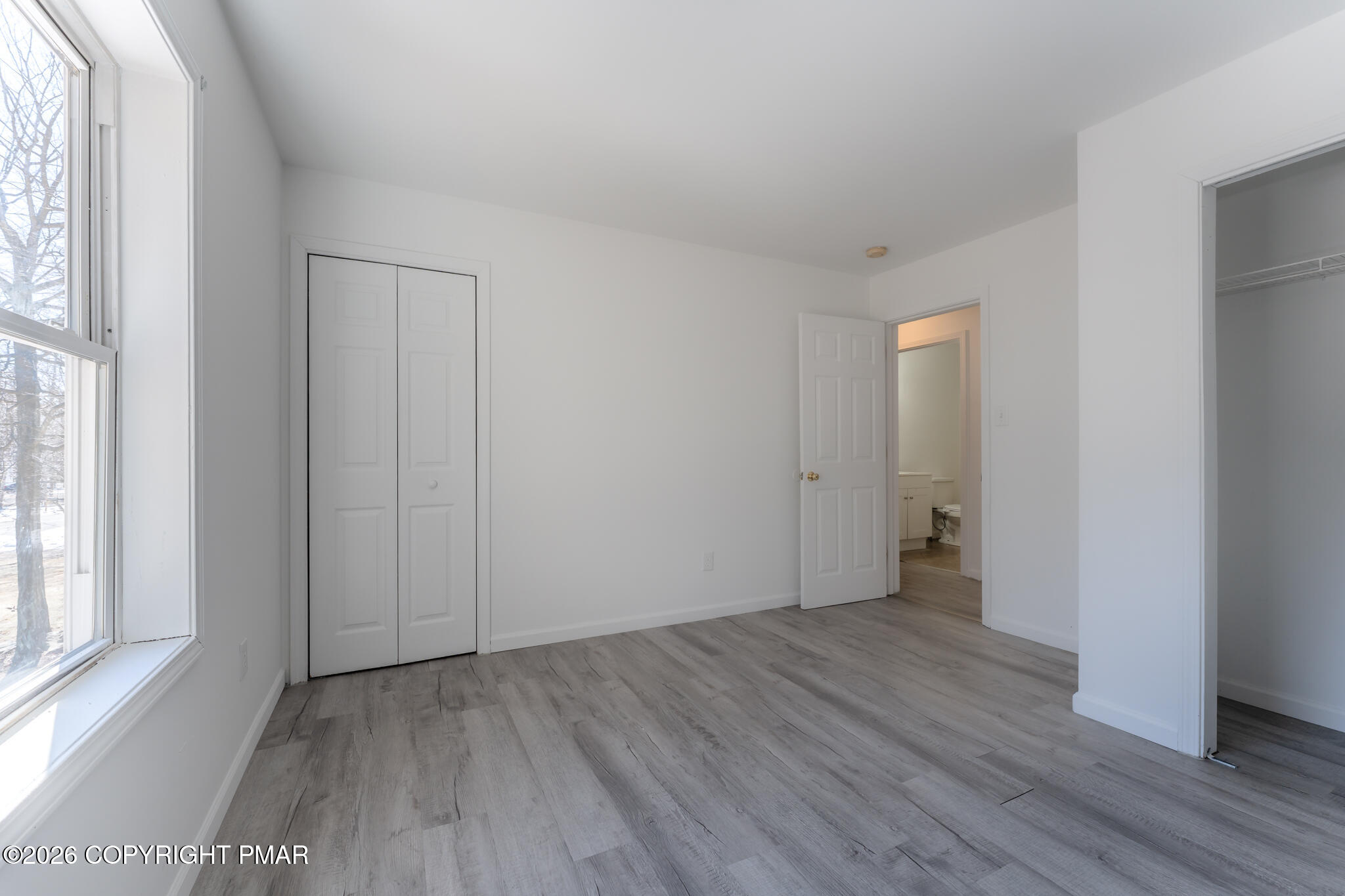 7624 Sawmill Road Tobyhanna, PA 18466 - Photo 41 of 55 a view of an empty room with wooden floor and a window