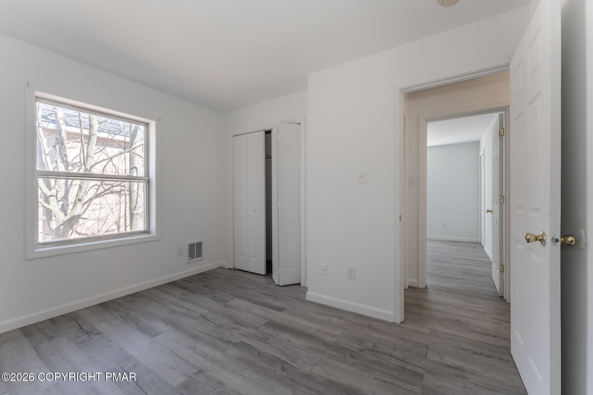 7624 Sawmill Road Tobyhanna, PA 18466 - Photo 42 of 55 an empty room with wooden floor and windows