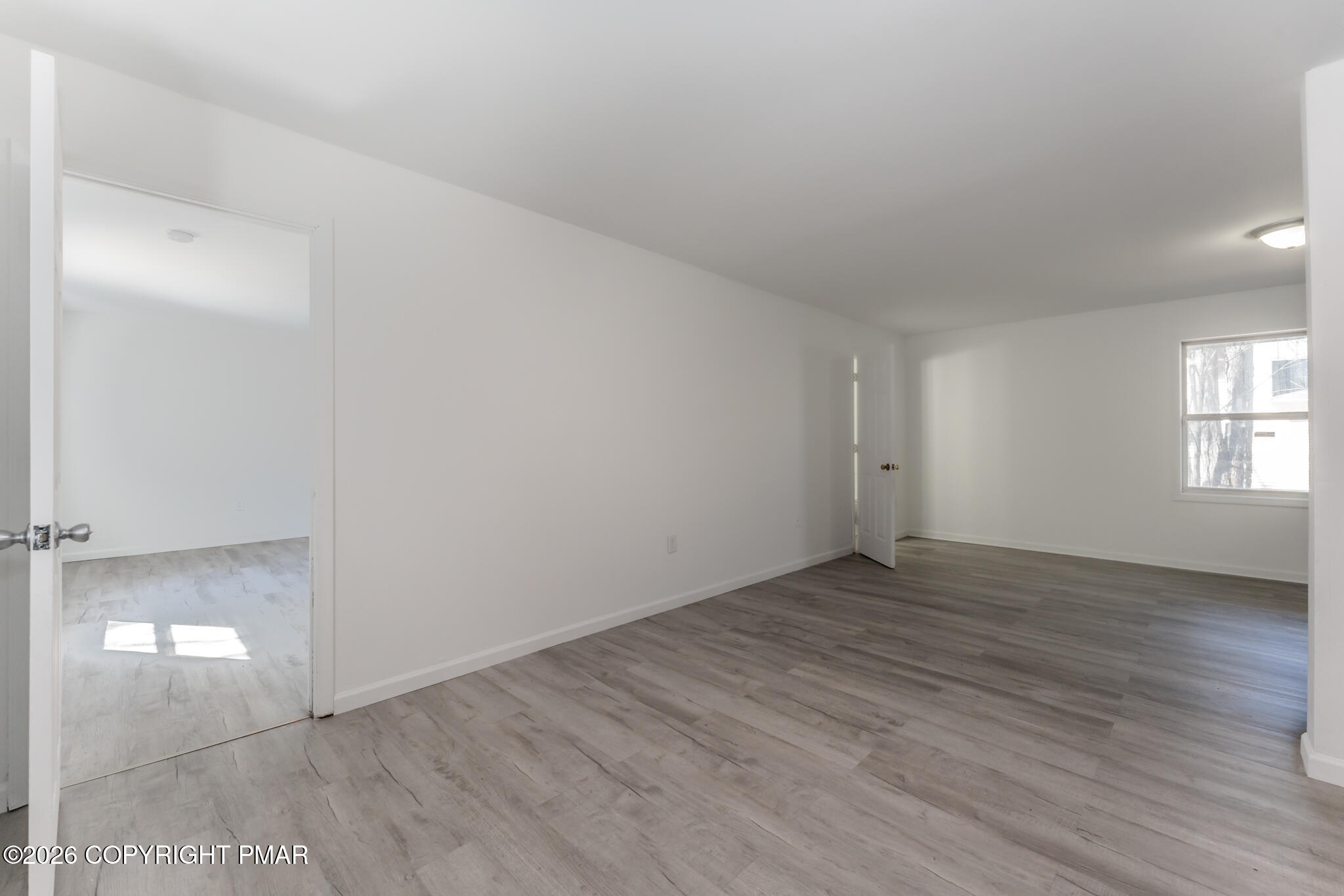 7624 Sawmill Road Tobyhanna, PA 18466 - Photo 10 of 55 an empty room with wooden floor and windows