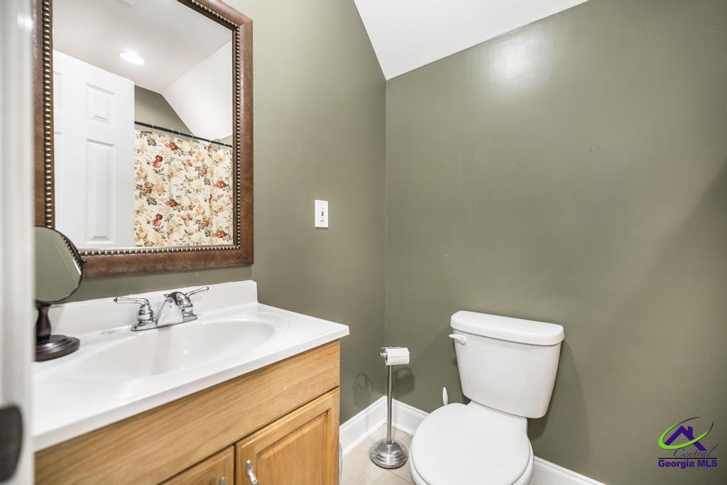 204 Smith Road Haddock, GA 31033 - Photo 35 of 51 a bathroom with a sink vanity mirror and toilet