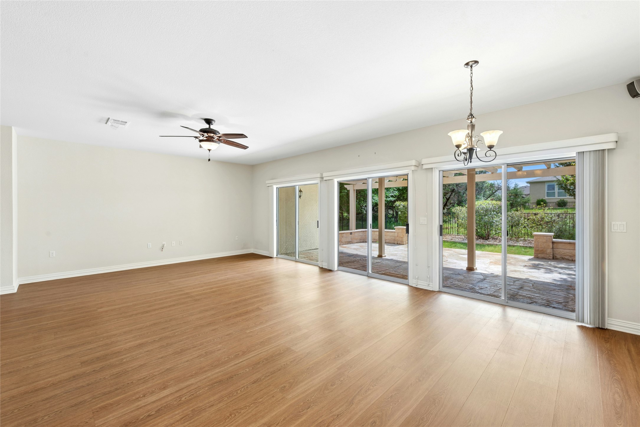 227 Duck Creek Lane Georgetown, TX 78633 - Photo 11 of 40 a view of an empty room with wooden floor and a window