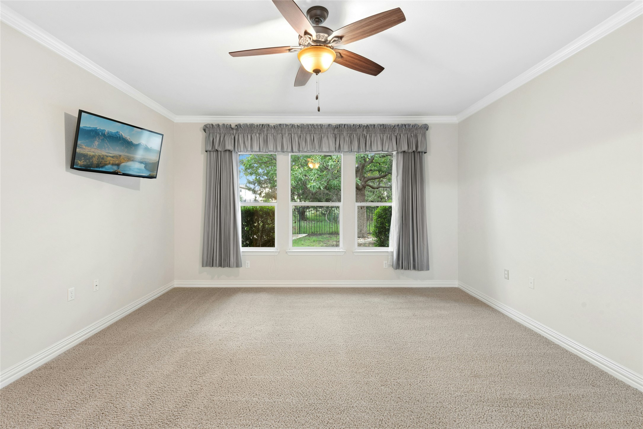 227 Duck Creek Lane Georgetown, TX 78633 - Photo 15 of 40 a view of an empty room with window and a ceiling fan