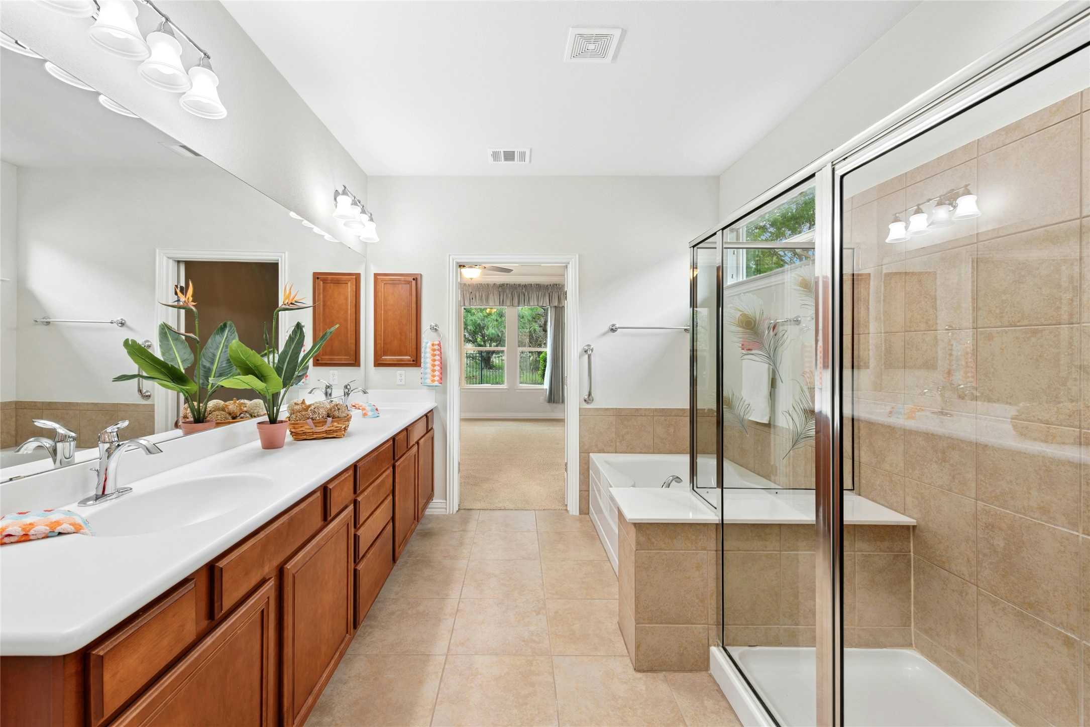 227 Duck Creek Lane Georgetown, TX 78633 - Photo 17 of 40 a bathroom with a double vanity sink and mirror