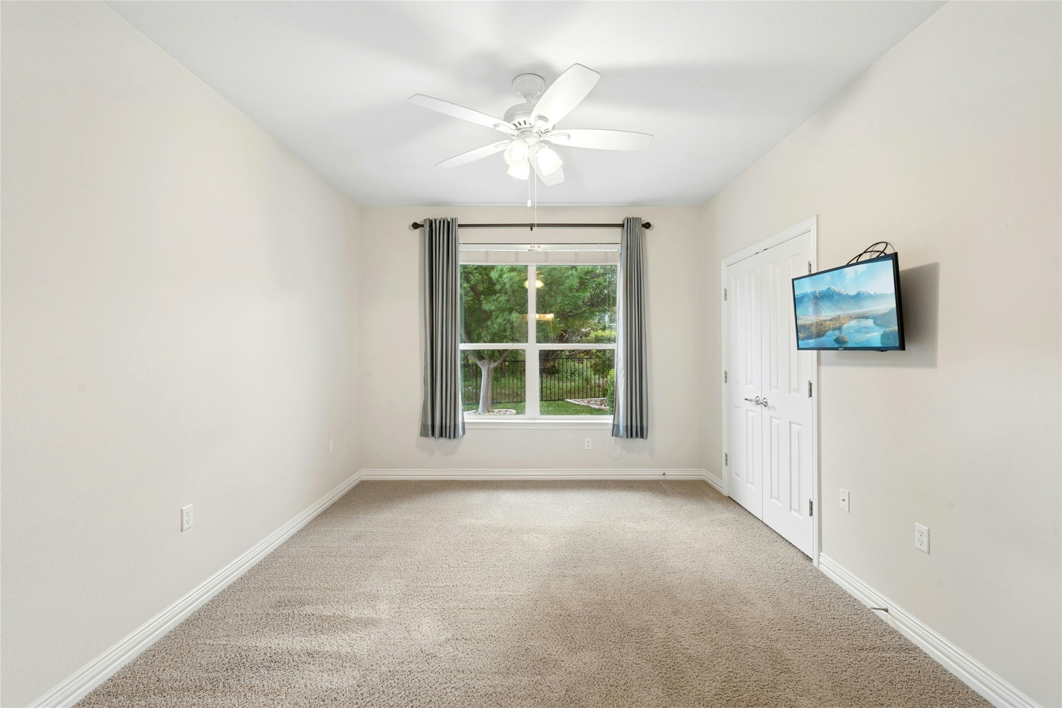 227 Duck Creek Lane Georgetown, TX 78633 - Photo 22 of 40 an empty room with windows and ceiling fan