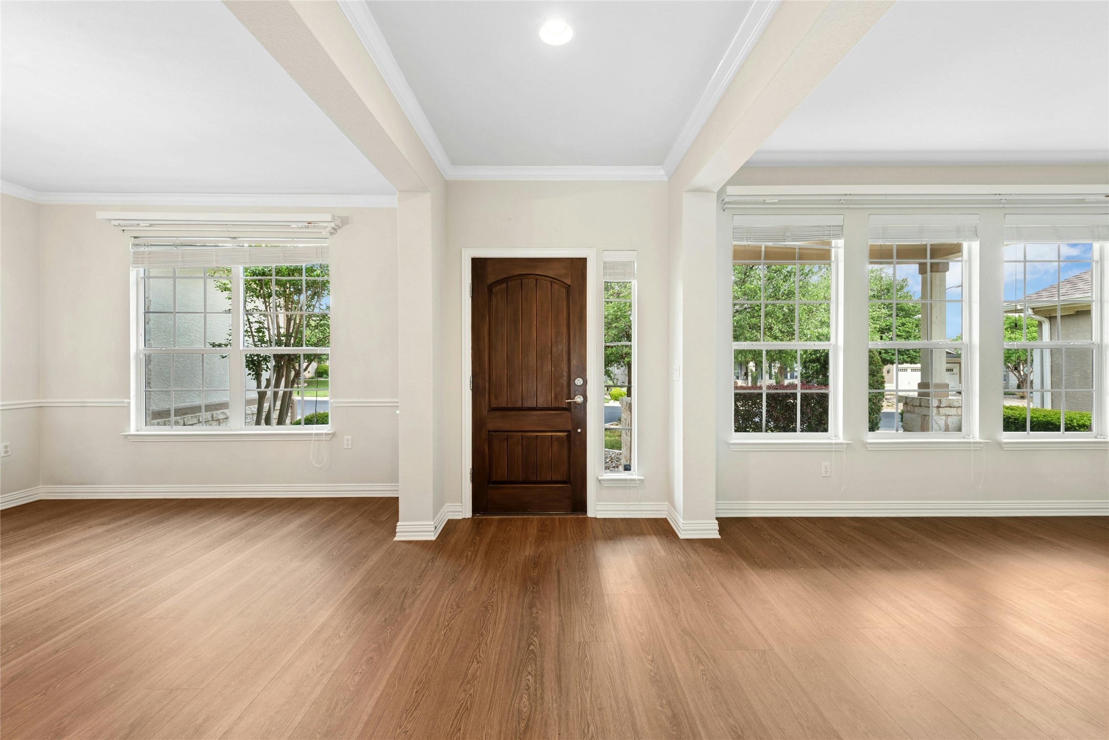 227 Duck Creek Lane Georgetown, TX 78633 - Photo 2 of 40 a view of an empty room with wooden floor and a window