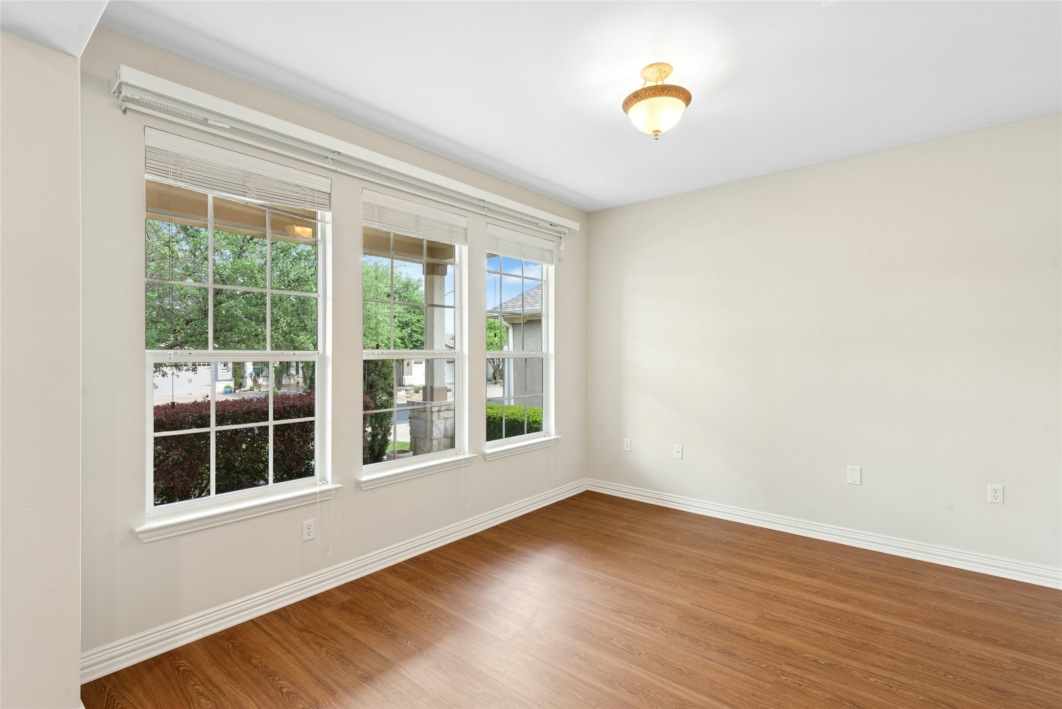 227 Duck Creek Lane Georgetown, TX 78633 - Photo 3 of 40 a view of an empty room with wooden floor and windows