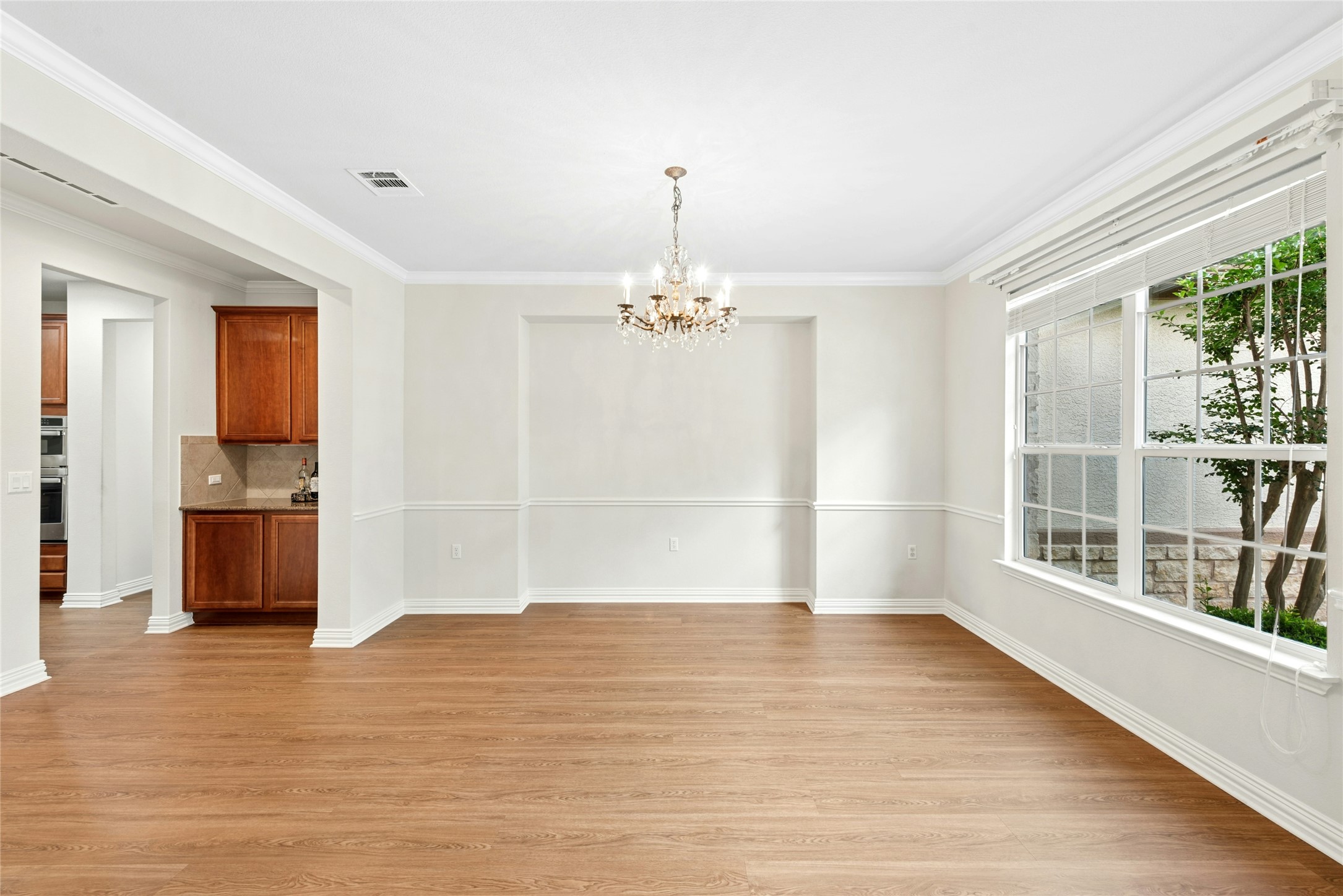 227 Duck Creek Lane Georgetown, TX 78633 - Photo 4 of 40 a view of empty room with wooden floor and outdoor view