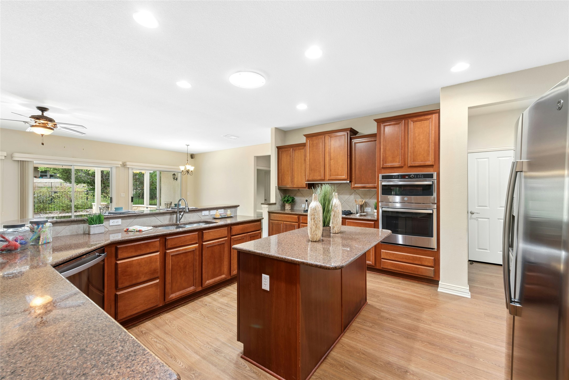 227 Duck Creek Lane Georgetown, TX 78633 - Photo 6 of 40 a large kitchen with kitchen island granite countertop a large counter top stainless steel appliances and cabinets
