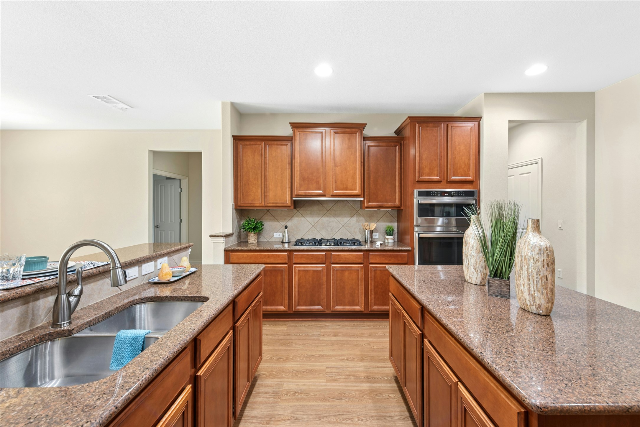 227 Duck Creek Lane Georgetown, TX 78633 - Photo 7 of 40 a kitchen with kitchen island granite countertop a sink a counter top space stove and cabinets