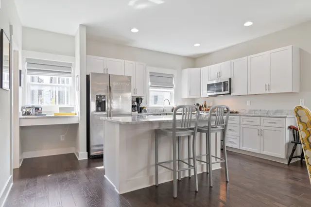 a kitchen with stainless steel appliances granite countertop a refrigerator and a sink