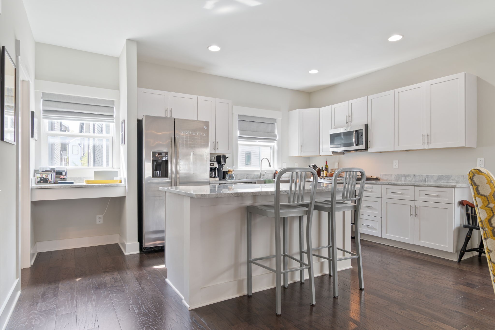 728 Centerpoint Lane Nashville, TN 37209 - Photo 22 of 45 a kitchen with stainless steel appliances granite countertop a stove a sink a refrigerator white cabinets and a dining table with wooden floor