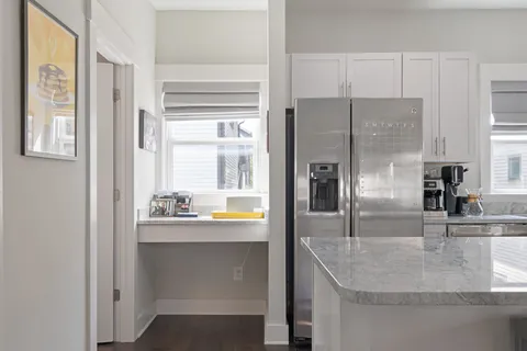 a kitchen with white cabinets stainless steel appliances and sink