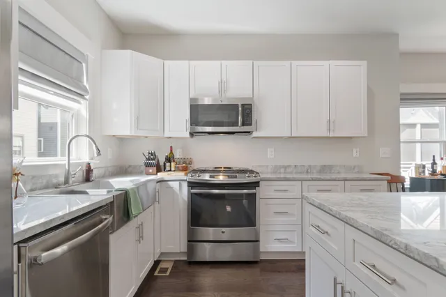 a kitchen with sink cabinets and stainless steel appliances