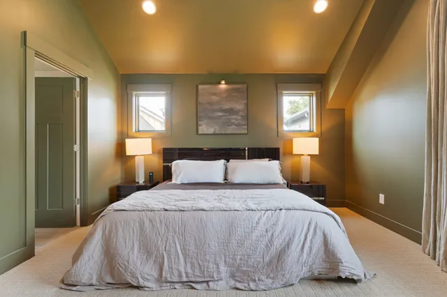 a bed room with a bed and a window