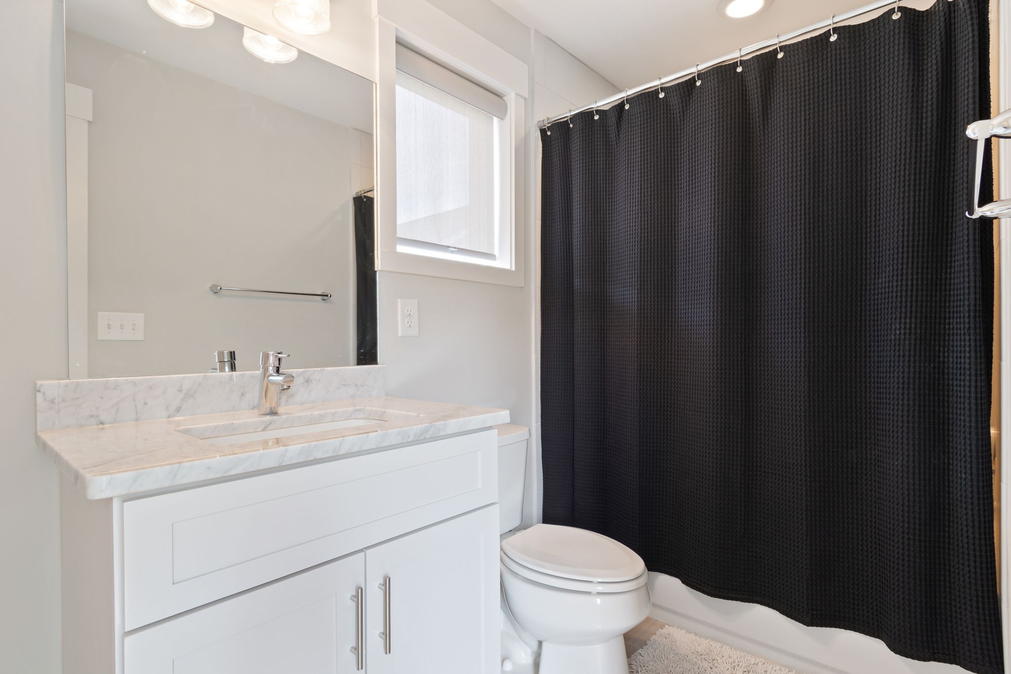 728 Centerpoint Lane Nashville, TN 37209 - Photo 42 of 45 a bathroom with sink a toilet a mirror and shower curtain