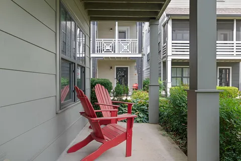a front view of a house with outdoor seating and plants