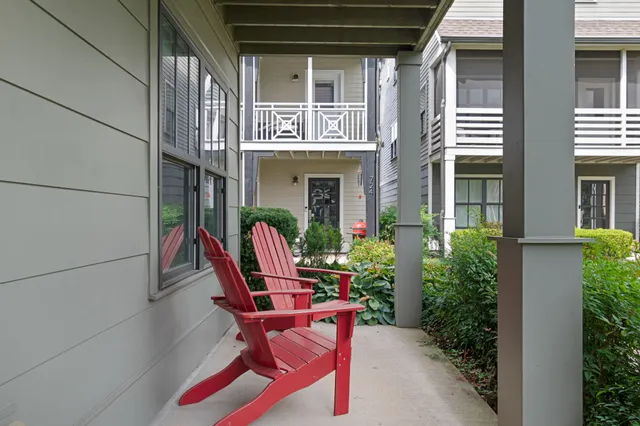 a front view of a house with outdoor seating and plants