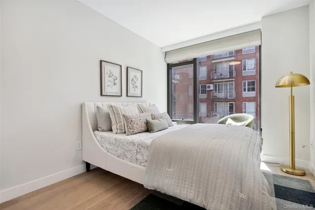 a bedroom with a bed and painting on the wall