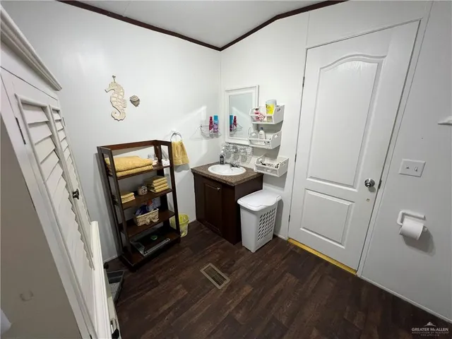 a room that has painting on the wall and a dresser