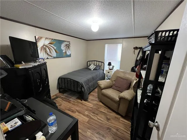 a bedroom with furniture and a flat screen tv