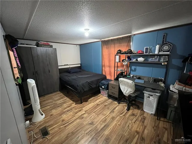 a bedroom with furniture and a dresser