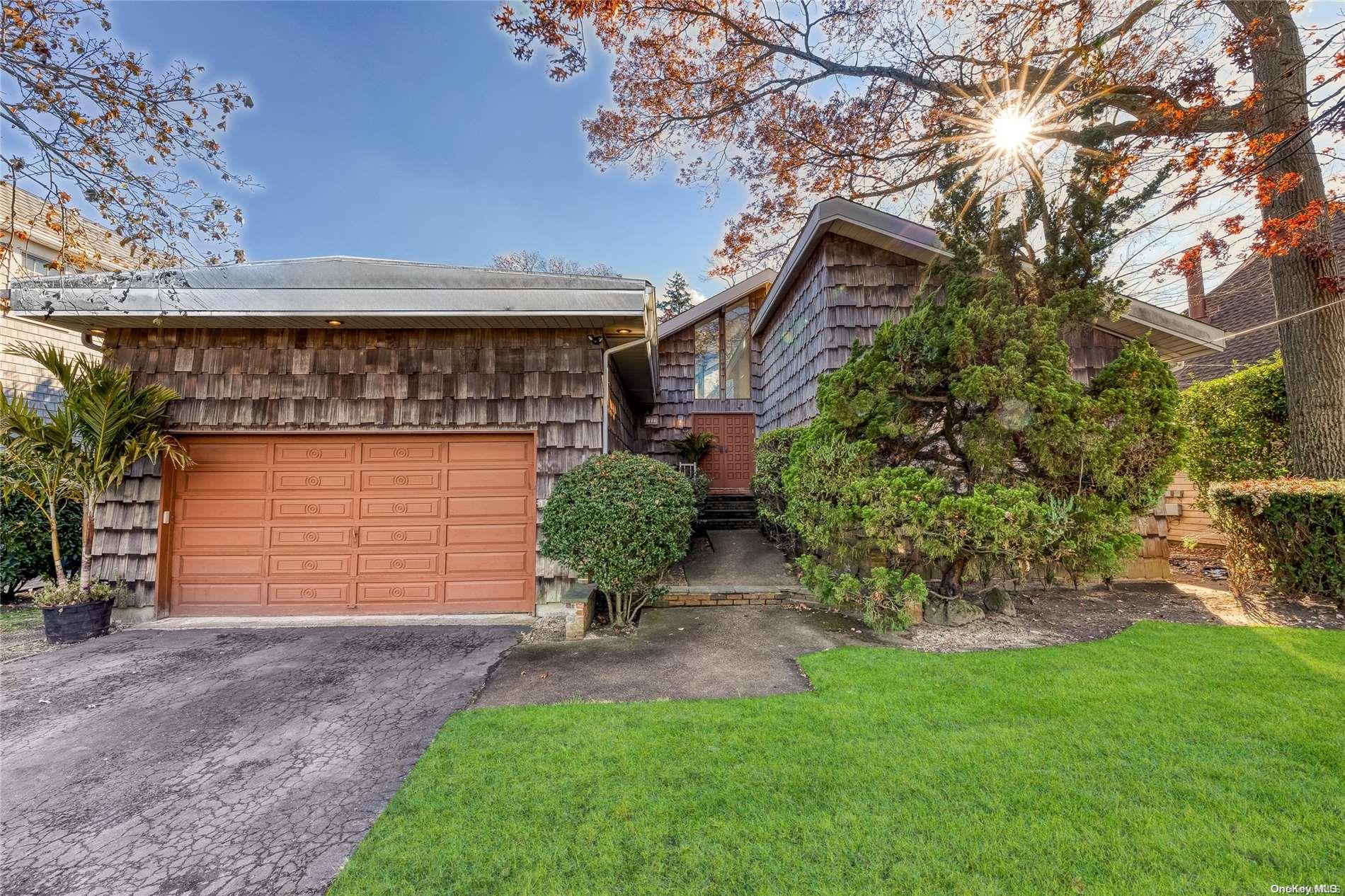 1822 Yale Road Merrick, NY 11566 - Photo 1 of 1 a front view of a house with garden