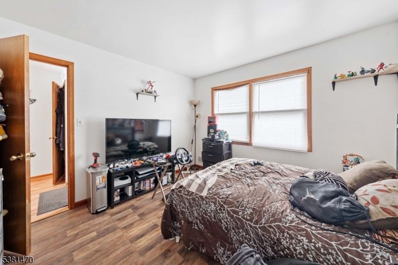 1 Hall Street Piscataway, NJ 08854 - Photo 13 of 21 a bedroom with a bed and a flat screen tv