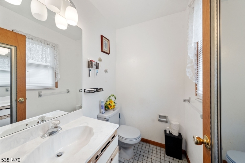 1 Hall Street Piscataway, NJ 08854 - Photo 15 of 21 a bathroom with a sink mirror and toilet