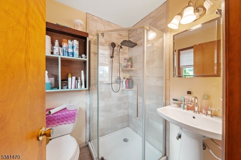1 Hall Street Piscataway, NJ 08854 - Photo 9 of 21 a bathroom with a sink vanity mirror and toilet