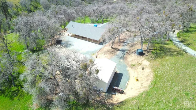 an aerial view of residential house with pool and garden