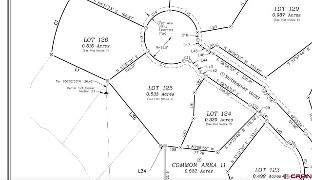 a picture of a field with a next to a wall