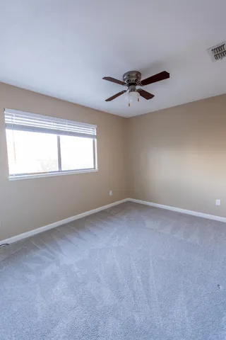a view of a big room with windows and closet
