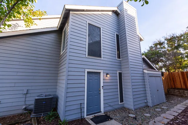 a front view of a house with a garden