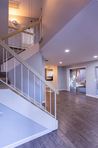a view of a livingroom with an empty space wooden floor and window