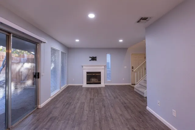 a view of a livingroom with a fireplace and window