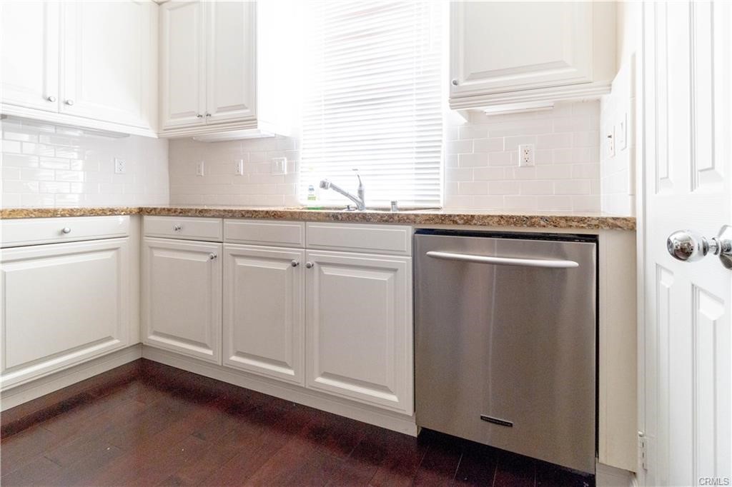 77 Canal Irvine, CA 92620 - Photo 3 of 9 a kitchen with granite countertop white cabinets and white appliances