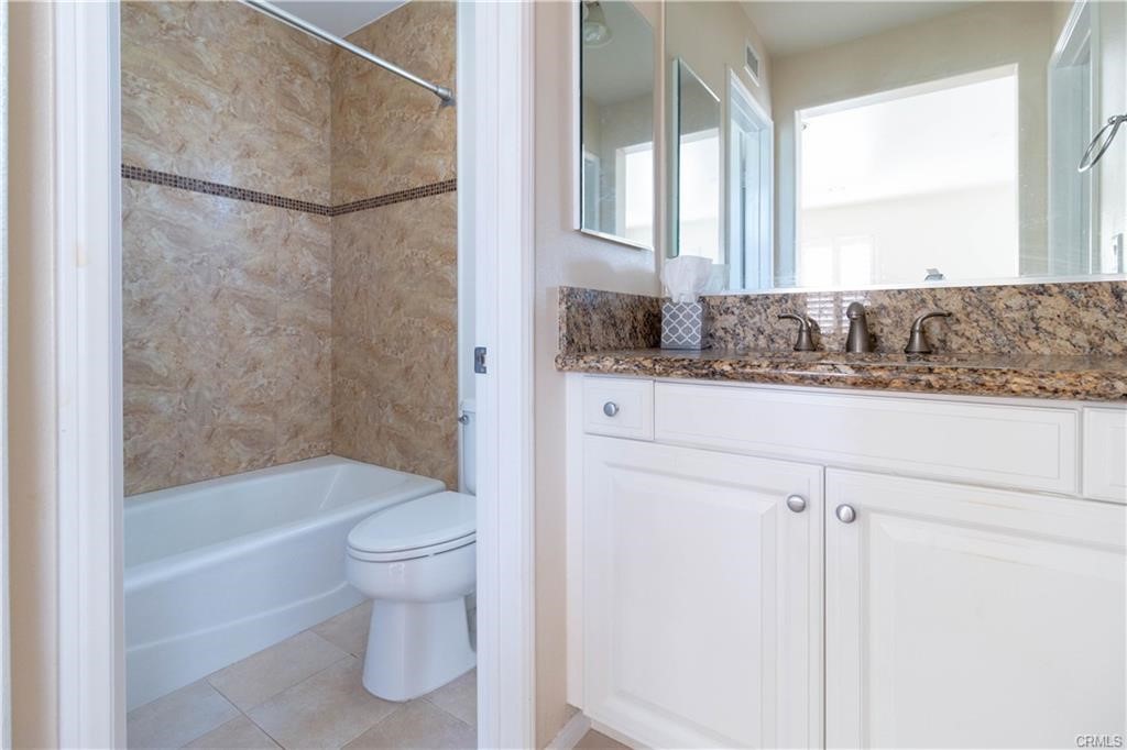 77 Canal Irvine, CA 92620 - Photo 7 of 9 a bathroom with a granite countertop sink a toilet and shower