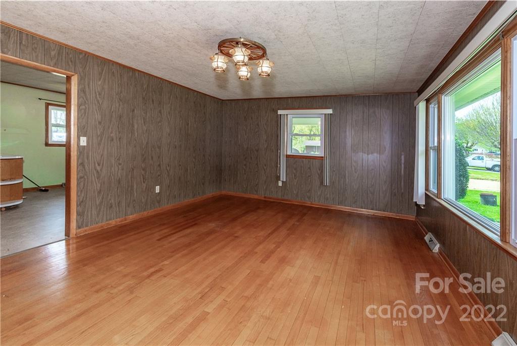 2 Riversedge Way Canton, NC 28716 - Photo 11 of 28 an empty room with wooden floor and windows