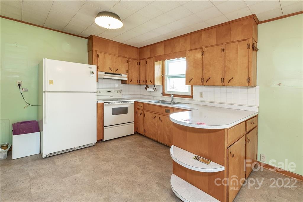 2 Riversedge Way Canton, NC 28716 - Photo 13 of 28 a kitchen with a sink a stove a refrigerator and a refrigerator