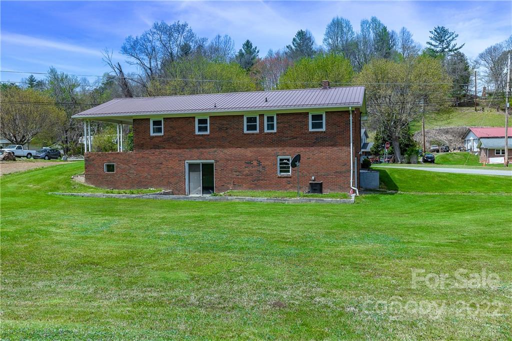 2 Riversedge Way Canton, NC 28716 - Photo 3 of 28 a view of a yard in front of a house with a large tree