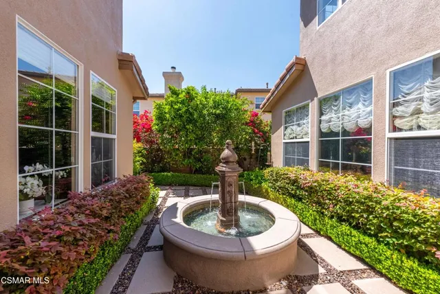 a living room with furniture large window and a fireplace