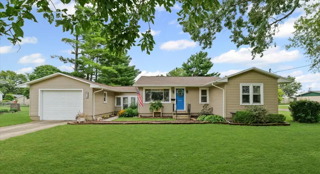 a front view of house with yard and green space
