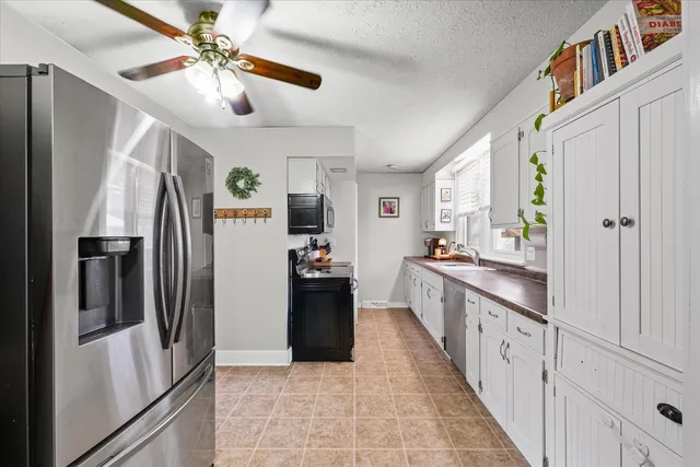 a large kitchen with cabinets and stainless steel appliances