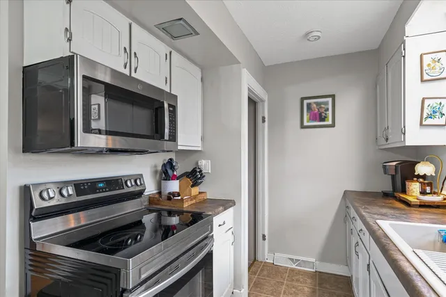 a kitchen with stainless steel appliances a stove a microwave and cabinets