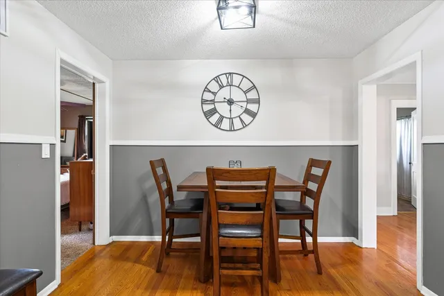 a view of a dining room with furniture and wooden floor