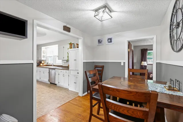a open kitchen with a table chairs refrigerator and cabinets