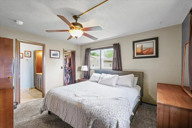 a bedroom with a large bed and a chandelier