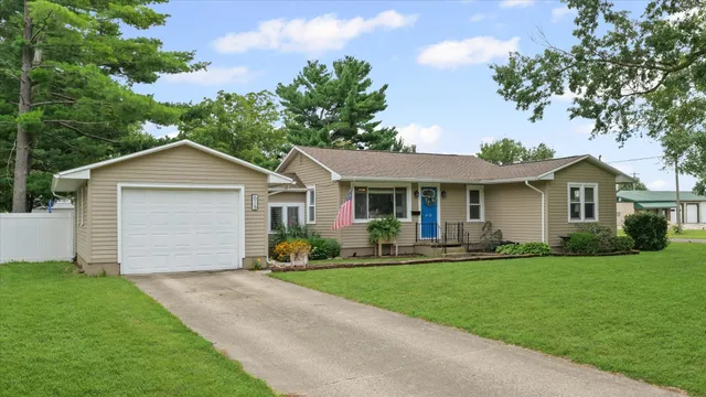 a front view of house with yard and green space