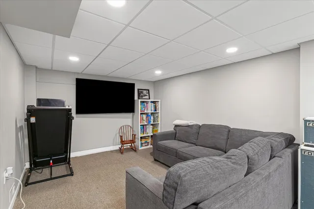 a view of a house with backyard and sitting area