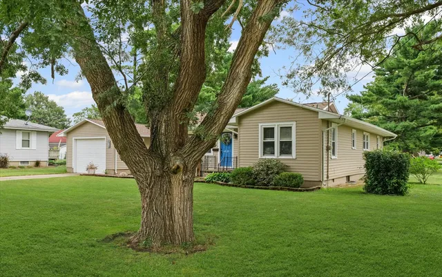 a big house with a big yard and large trees